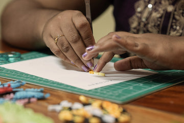 A Vonderly artisan using tweezers to place a quilled paper line onto a card, in the studio in Jaffna, Sri Lanka.