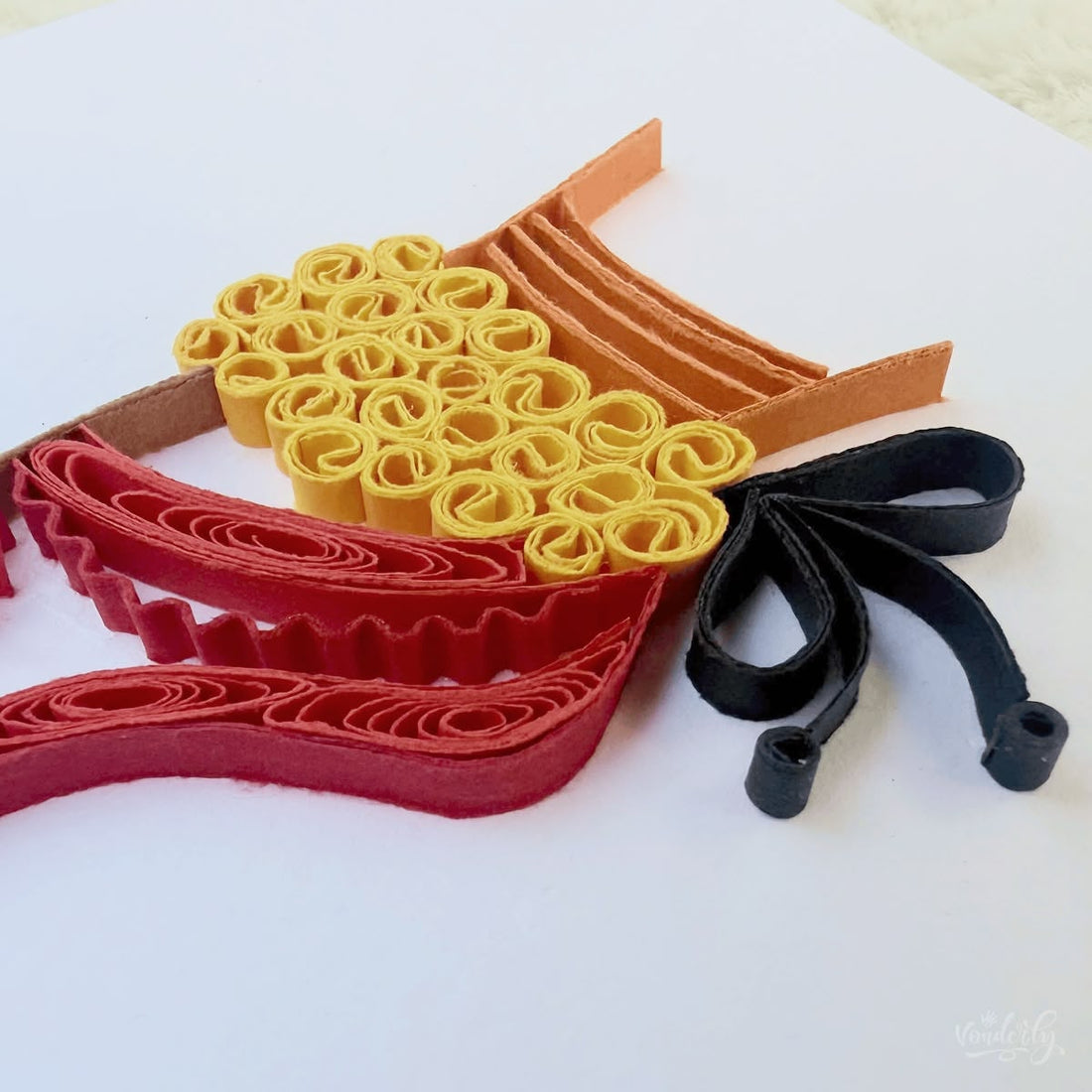 Handmade quilled Bharatanatyam dance greeting card, dancer's leg in classical pose with golden ankle bells, red alta foot, and coral striped costume hem, paper art by Vonderly