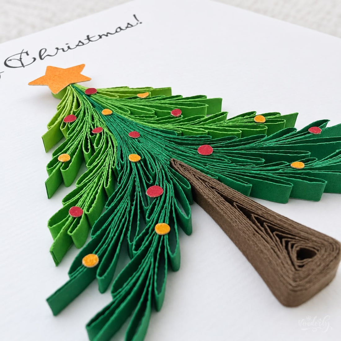 Christmas Tree quilled greeting card with a green fringed paper pine, orange star, and red and gold ornaments, printed "Merry Christmas!" above.