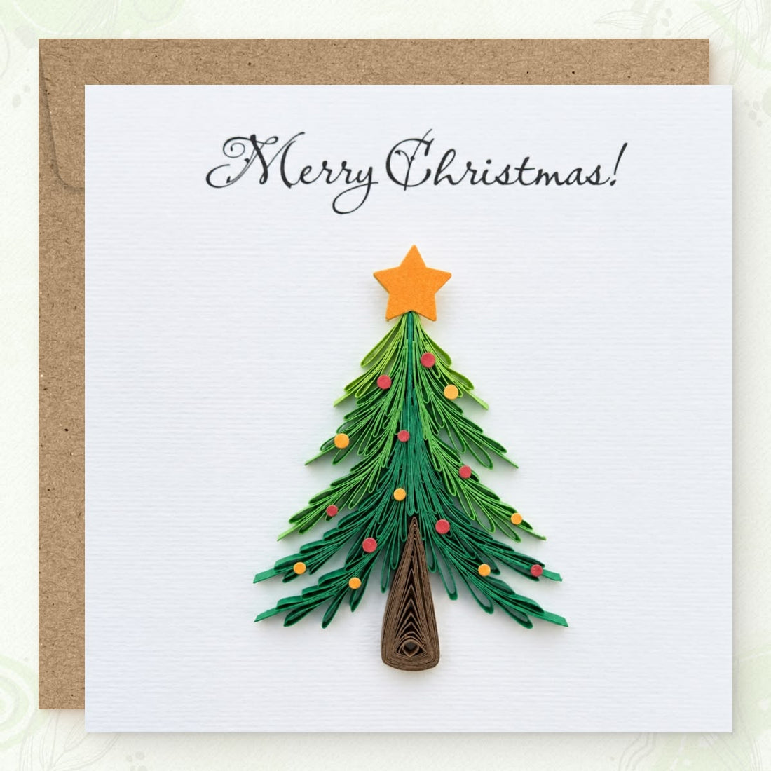 Christmas Tree quilled greeting card with a green fringed paper pine, orange star, and red and gold ornaments, printed "Merry Christmas!" above.