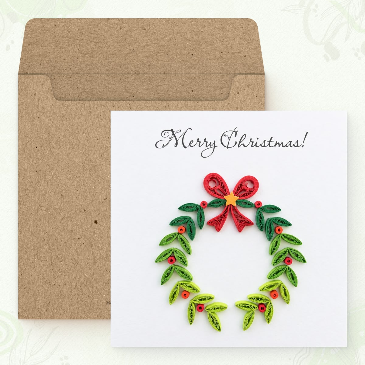 Christmas Wreath quilled greeting card shown with its square kraft envelope.