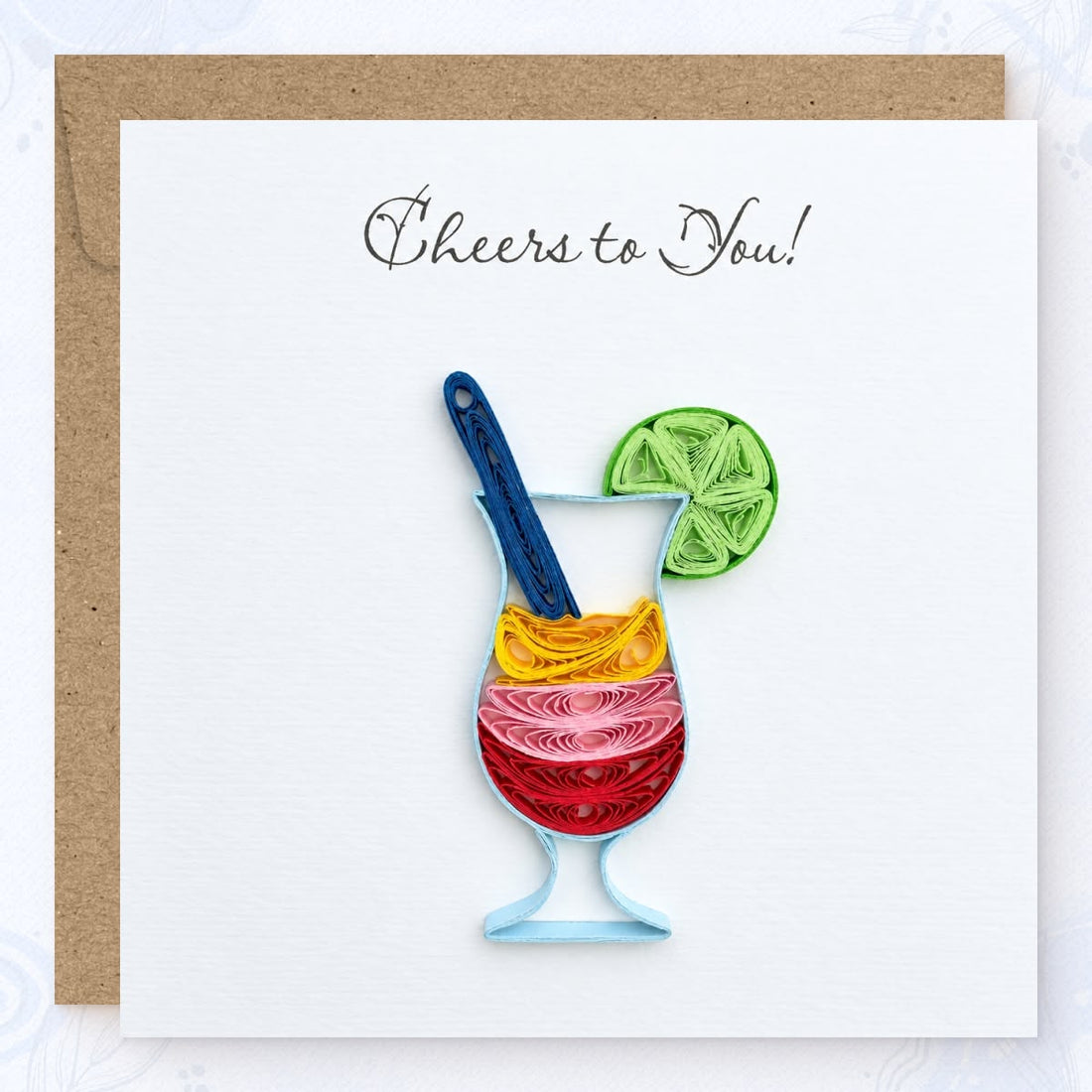Quilled greeting card with a layered paper drink in a tall glass, a navy stick, and a green lime wheel.