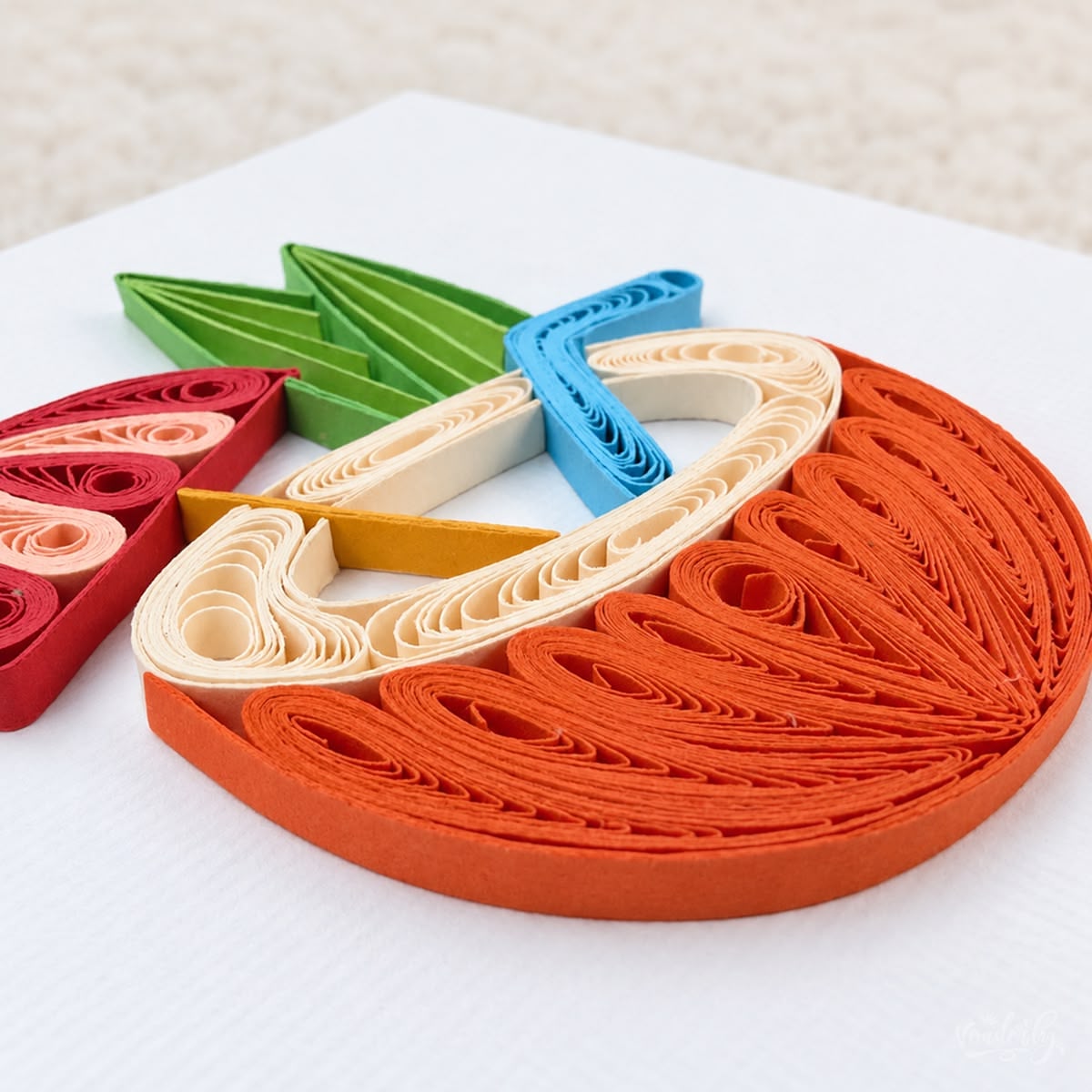 Angled view of the Coconut Drink card showing the raised orange coils of the shell and the cream rim.