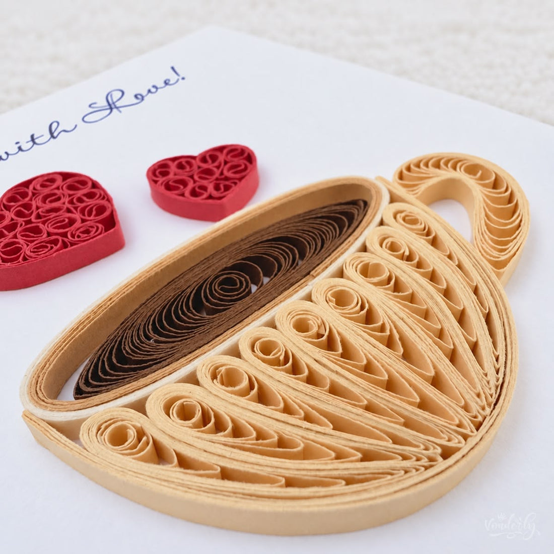 Coffee Cup quilled greeting card with a gold paper cup of brown coffee and two red hearts above it, printed "Brewed with Love!" at the top.