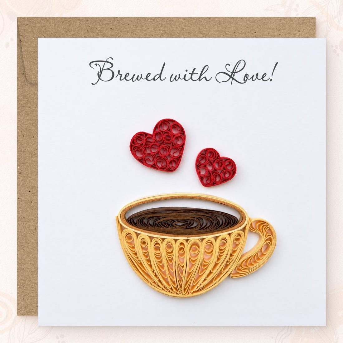 Coffee Cup quilled greeting card with a gold paper cup of brown coffee and two red hearts above it, printed "Brewed with Love!" at the top.