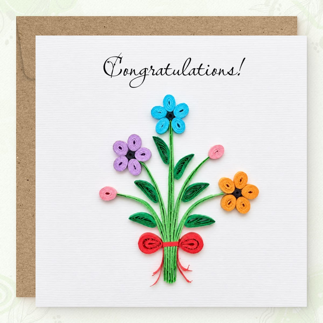 Congratulations greeting card with a quilled bouquet in blue, purple, and yellow paper flowers under black script.
