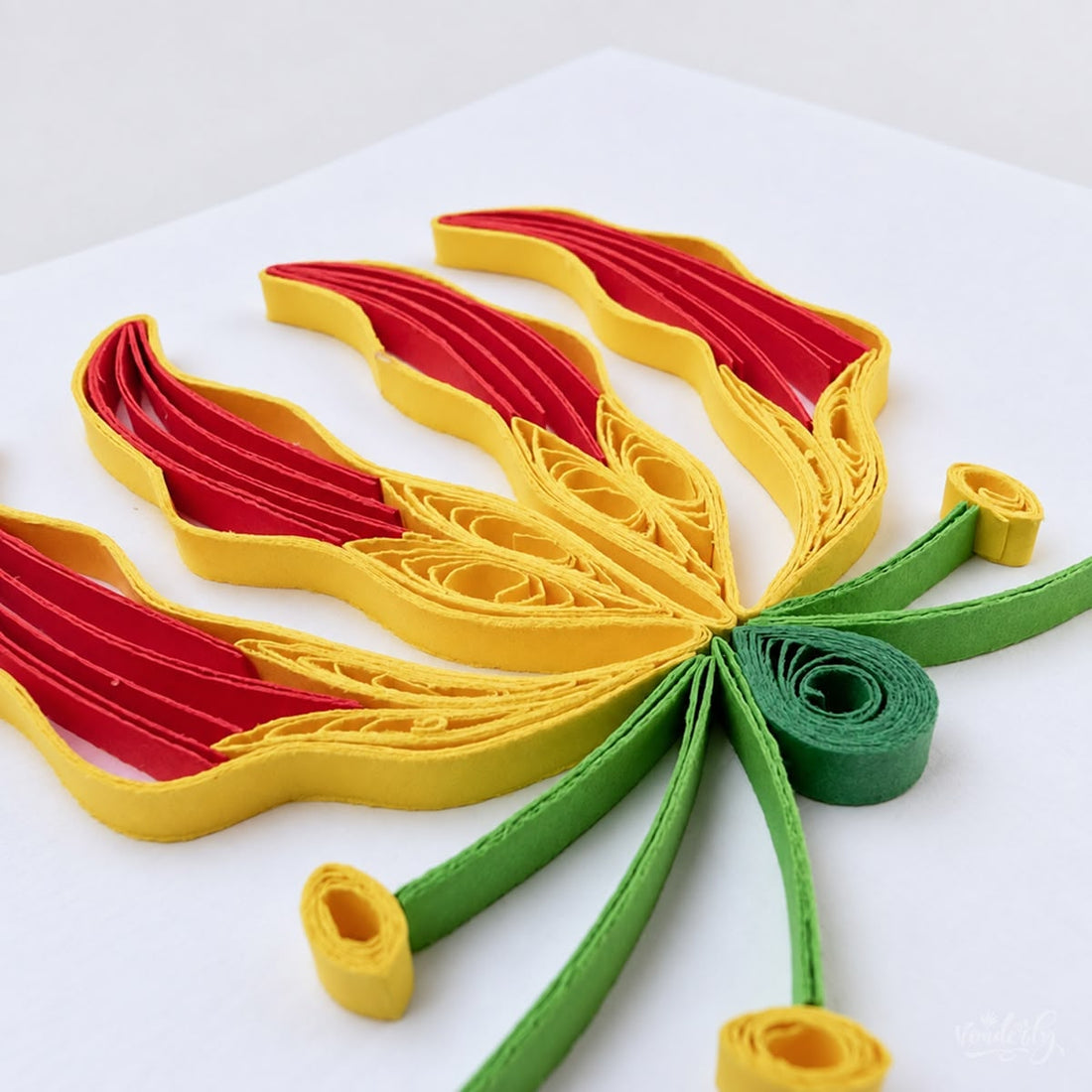 Flame lily quilled greeting card with four red and yellow petals and green stems.