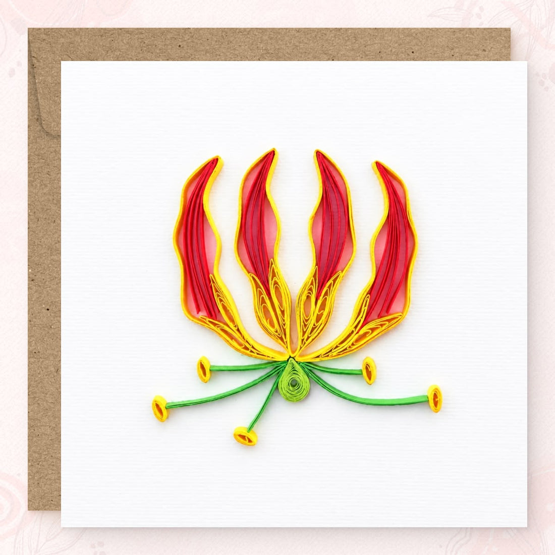 Flame lily quilled greeting card with four red and yellow petals and green stems.