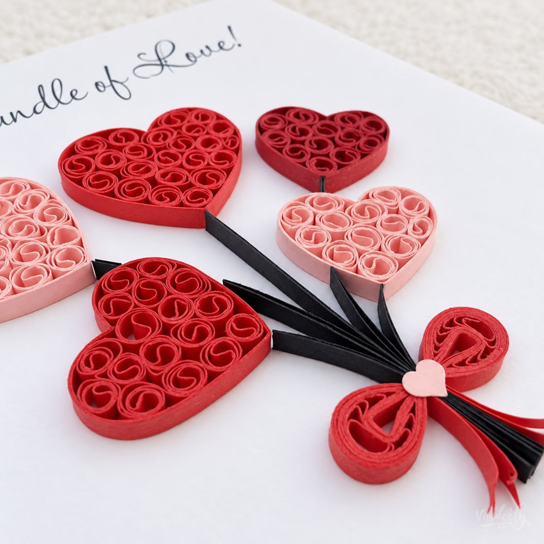 Heart Balloons quilled greeting card with five coil-filled hearts in red and pink paper on black strings, printed "Bundle of Love!" above.