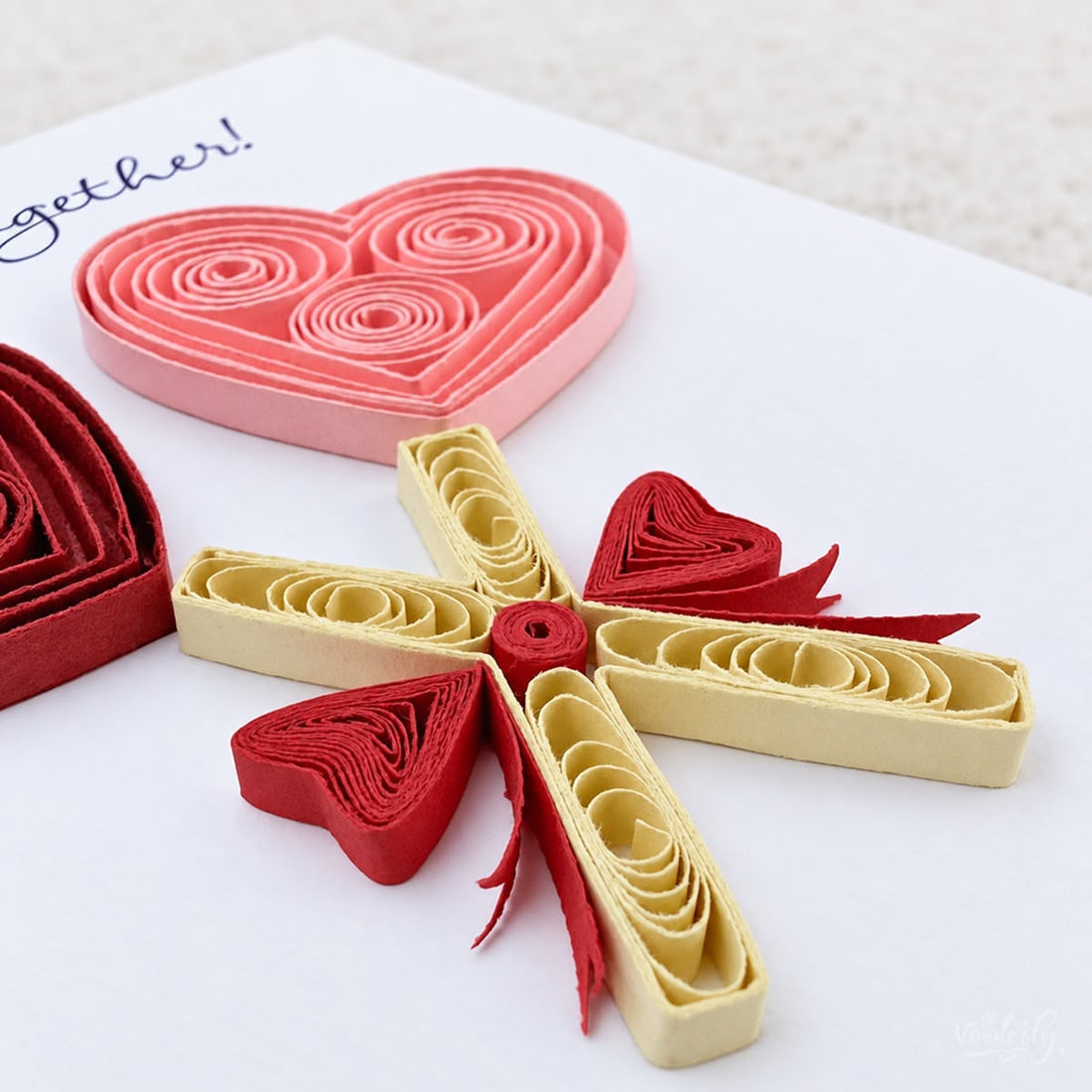 Heart Lollipops quilled greeting card with deep red and pink paper hearts on crossed cream sticks, printed "Sweetest Together!" above.