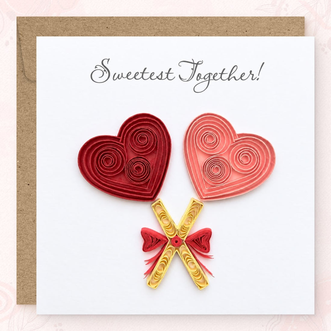Heart Lollipops quilled greeting card with deep red and pink paper hearts on crossed cream sticks, printed "Sweetest Together!" above.