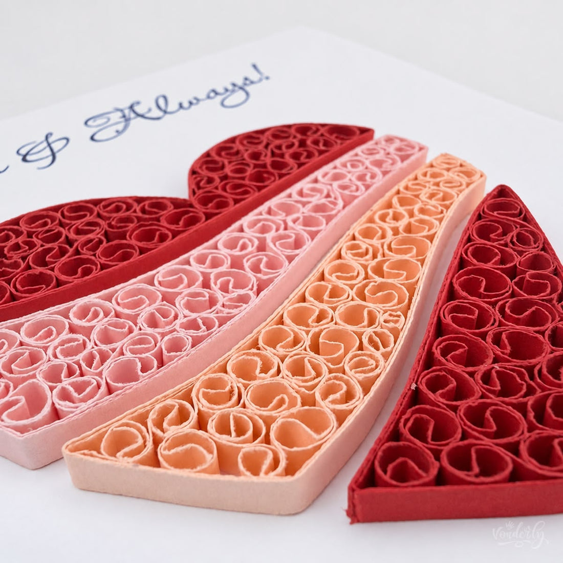Quilled anniversary card with a heart filled with red, pink, and peach paper coils.