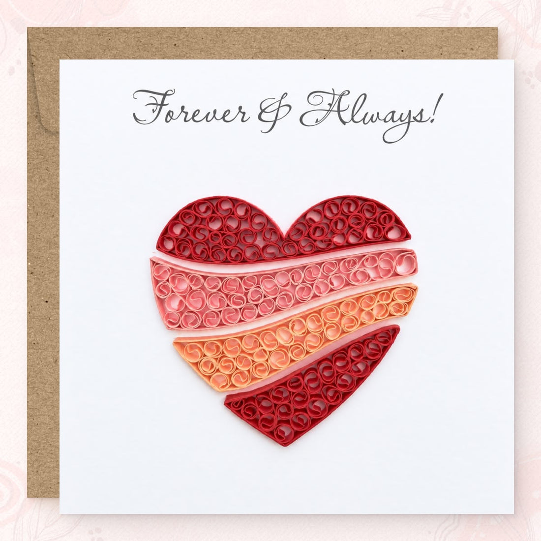 Quilled anniversary card with a heart filled with red, pink, and peach paper coils.