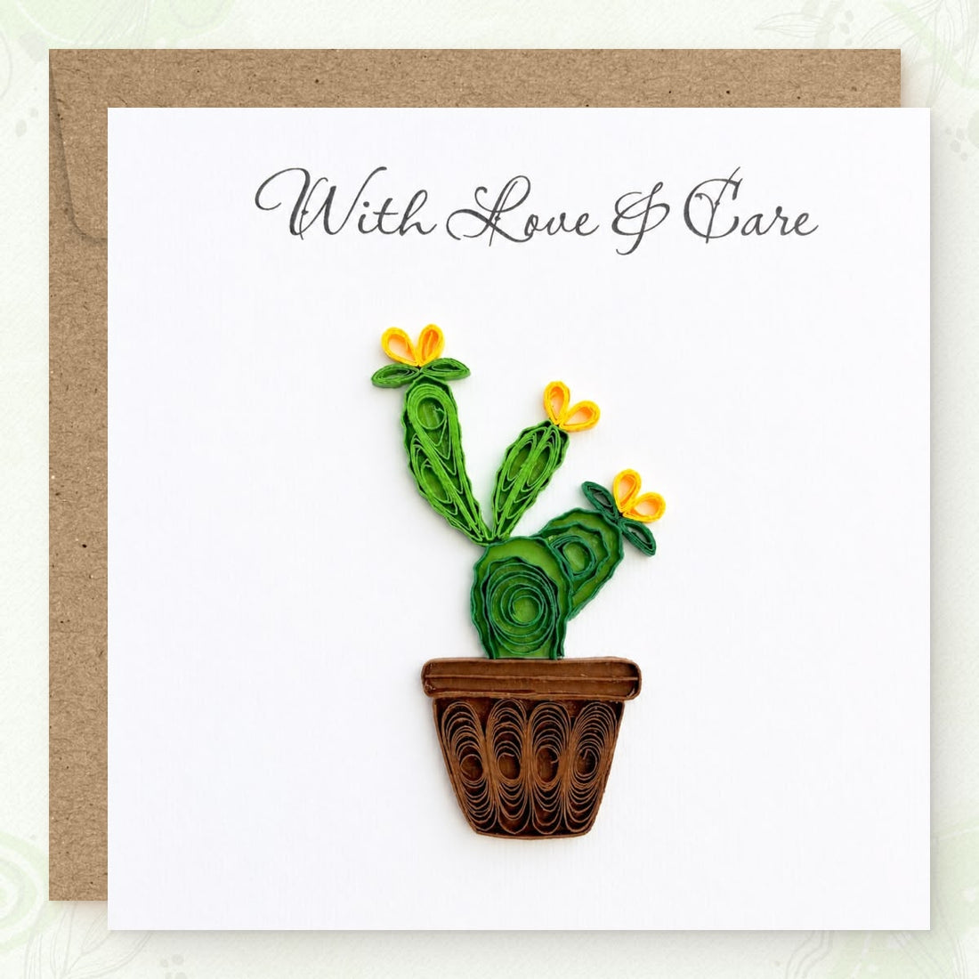 Prickly Pear quilled greeting card with green paper cactus pads, three yellow blooms, and a brown pot, printed "With Love & Care" above.
