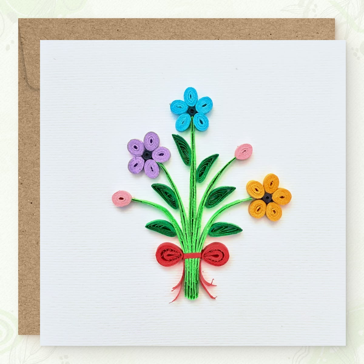 Handmade quilled flower bouquet greeting card, three flowers (blue, lavender, orange) with two pink buds on gathered green stems tied with a red ribbon, paper art by Vonderly