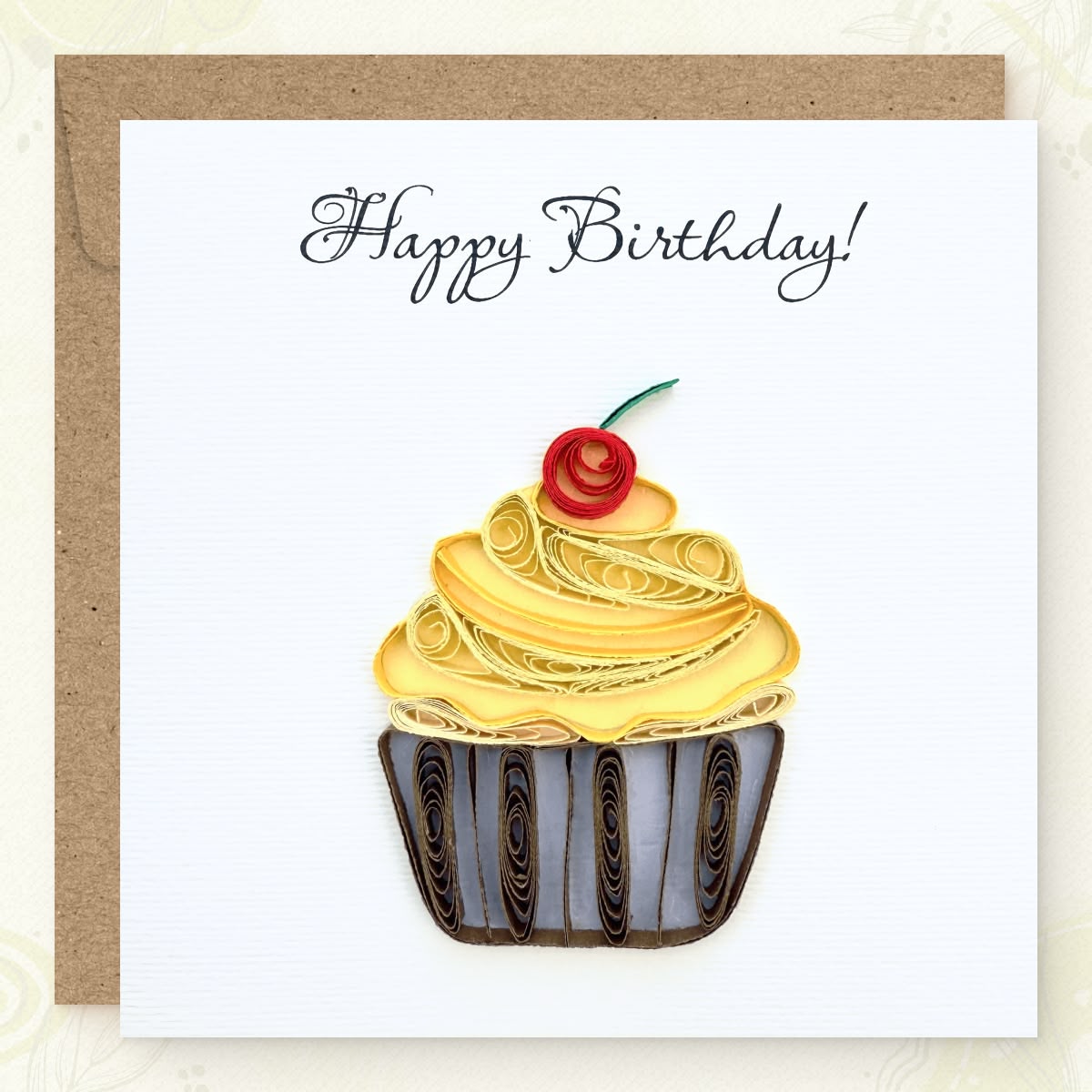 Handmade quilled birthday greeting card with a gold frosting cupcake, red cherry, and striped wrapper, "Happy Birthday" in calligraphic script, paper art by Vonderly
