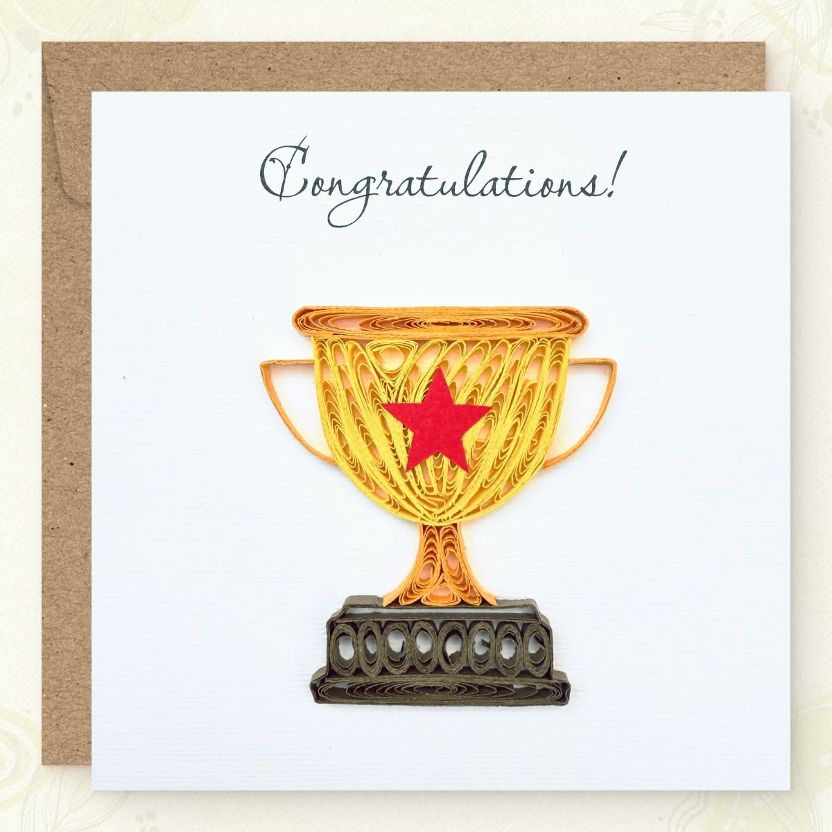 Handmade quilled congratulations greeting card with a gold championship trophy and red star, dark brown base, "Congratulations" printed in calligraphic script, paper art by Vonderly