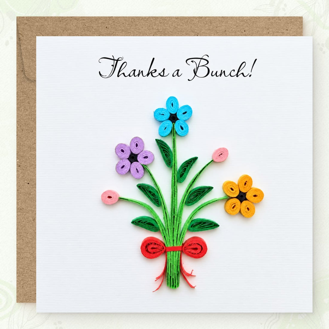 Thank you greeting card with a quilled bouquet in blue, purple, and yellow paper flowers under black script.