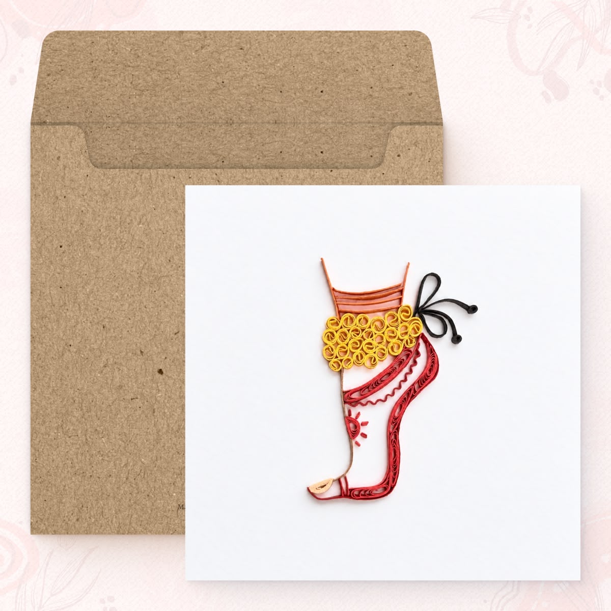 The Dancer quilled greeting card shown with its square kraft envelope.