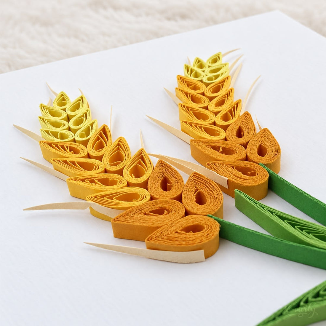 Wheat Stalks quilled greeting card with two paper wheat heads in yellow, gold, and orange above green leaves.